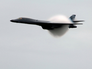 16. A U.S. Air Force B-1B Lancer Heavy Bomber Creates A Prandtl-Glauert Cloud at the Selfridge 2009 Air Show on August 23, 2009, Selfridge Air National Guard Base, State of Michigan, USA. Reaching the sound barrier, breaking the sound barrier: Flying at transonic speeds (flying transonically) -- speeds varying near and at the speed of sound (supersonic) -- can generate impressive condensation clouds caused by the Prandtl-Glauert Singularity. For a scientific explanation, see Professor M. S. Cramer's Gallery of Fluid Mechanics, Prandtl-Glauert Singularity at <http://www.GalleryOfFluidMechanics.com/conden/pg_sing.htm>; and Foundations of Fluid Mechanics, Navier-Stokes Equations Potential Flows: Prandtl-Glauert Similarity Laws at <http://www.Navier-Stokes.net/nspfsim.htm>. Photo Credit: John S. Swanson; Defense Visual Information (DVI, http://www.DefenseImagery.mil, 090823-F-HC784-474 and 090823-F-9232-474) and United States Air Force (USAF, http://www.af.mil), United States Department of Defense (DoD, http://www.DefenseLink.mil or http://www.dod.gov), Government of the United States of America (USA).