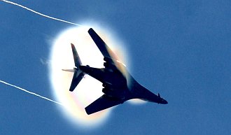 2. A B-1B Lancer Bomber Banks Left, United States Air Force. January 16, 2004, Southwest Asia. Flying at transonic speeds -- speeds varying near and at the speed of sound (supersonic) -- can generate impressive condensation clouds caused by the Prandtl-Glauert Singularity. For a scientific explanation, see Professor M. S. Cramer's Gallery of Fluid Mechanics, Prandtl-Glauert Singularity at <http://www.GalleryOfFluidMechanics.com/conden/pg_sing.htm>; and Foundations of Fluid Mechanics, Navier-Stokes Equations Potential Flows: Prandtl-Glauert Similarity Laws at <http://www.Navier-Stokes.net/nspfsim.htm>. Photo Credit: Staff Sgt. Shelley Gill, Still Photography Journeyman, 125th Fighter Wing, Florida Air National Guard, USA; Air Force Link - Photos (http://www.af.mil/photos, 040116-F-0971G-156, Breaking the barrier), United States Air Force (USAF, http://www.af.mil), United States Department of Defense (DoD, http://www.DefenseLink.mil or http://www.dod.gov), Government of the United States of America (USA). Additional information: The USAF B1-B Lancer photos leading to this one are in the ChamorroBible.org 3rd Collection of Prandtl-Glauert Condensation Clouds, a photo sequence presented on Umayanggan (Disiembre) 16, 2004. On the same day, January 16th, 2004, Staff Sgt. Shelley R. Gill photographed the same B1-B aircraft with a different Prandtl-Glauert condensation cloud. These photos are in the ChamorroBible.org 4th Collection of Prandtl-Glauert Condensation Clouds published on Umayanggan (Disiembre) 17, 2004.