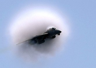 12. United States Navy F-14B Tomcat Assigned to the 'Swordsmen' of Fighter Squadron Three Two (VF-32), March 30, 2005, Mediterranean Sea. Flying at transonic speeds -- speeds varying near and at the speed of sound (supersonic) -- can generate impressive condensation clouds caused by the Prandtl-Glauert Singularity. For a scientific explanation, see Professor M. S. Cramer's Gallery of Fluid Mechanics, Prandtl-Glauert Singularity at <http://www.GalleryOfFluidMechanics.com/conden/pg_sing.htm>; and Foundations of Fluid Mechanics, Navier-Stokes Equations Potential Flows: Prandtl-Glauert Similarity Laws at <http://www.Navier-Stokes.net/nspfsim.htm>. Photo Credit: Photographer's Mate 3rd Class Justin S. Osborne, Navy NewsStand - Eye on the Fleet Photo Gallery (http://www.news.navy.mil/view_photos.asp, 050330-N-0382O-503), United States Navy (USN, http://www.navy.mil), United States Department of Defense (DoD, http://www.DefenseLink.mil or http://www.dod.gov), Government of the United States of America (USA).