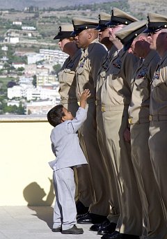 An eager little boy breaks from the gathered crowd to congratulate his father, a newly frocked chief petty officer, September 16, 2003. Naval Support Activity Gaeta, Repubblica Italiana - Italian Republic (Italy). Photo Credit: Photographer's Mate 1st Class Paul J. Phelps, Navy NewsStand - Eye on the Fleet Photo Gallery (http://www.news.navy.mil/view_photos.asp, 030916-N-2716P-120), United States Navy (USN, http://www.navy.mil), United States Department of Defense (DoD, http://www.DefenseLink.mil or http://www.dod.gov), Government of the United States of America (USA).