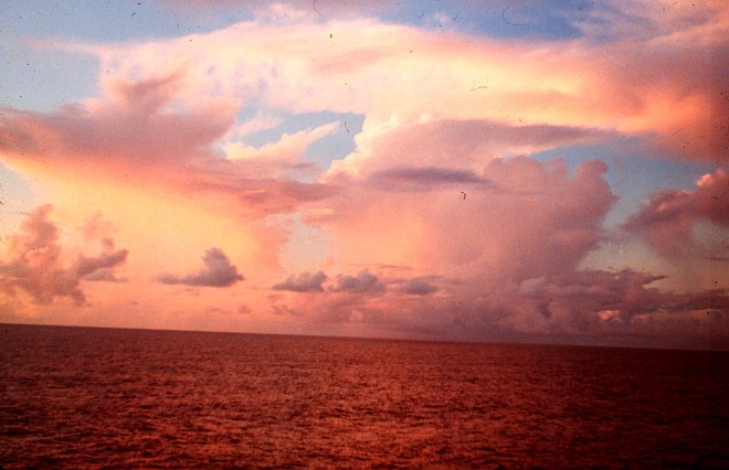 Beautiful Western Pacific Tropical Cumulonimbus and Other Clouds Painted in Orange and Yellow Hues, 1966. Near Territory of Guam, USA. Photo Credit: Captain Albert E. Theberge, NOAA Corps (ret.), National Oceanic and Atmospheric Administration Photo Library (http://www.photolib.noaa.gov, theb1439), Historic C&GS Collection, National Oceanic and Atmospheric Administration (NOAA, http://www.noaa.gov), United States Department of Commerce (http://www.commerce.gov), Government of the United States of America (USA).