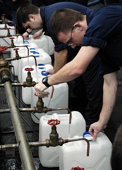 2. Filling Water Jugs with the Potable Water Manifold's Purified Water, January 4, 2005, USS Abraham Lincoln (CVN 72), Indian Ocean. Photo Credit: Photographer's Mate Airman Jordon R. Beesley, Navy NewsStand - Eye on the Fleet Photo Gallery (http://www.news.navy.mil/view_photos.asp, 050104-N-4166B-159), United States Navy (USN, http://www.navy.mil), United States Department of Defense (DoD, http://www.DefenseLink.mil or http://www.dod.gov), Government of the United States of America (USA).