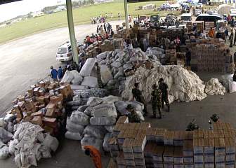 2. Food, Medical Supplies, Water, and Other Relief Supplies in an Aircraft Hanger at Sultan  Iskandar Muda Airport, January 2, 2005. Sumatra, Republik Indonesia. Photo Credit: Photographer's 3rd Class Bernardo Fuller, Navy NewsStand - Eye on the Fleet Photo Gallery (http://www.news.navy.mil/view_photos.asp, 050102-N-5362F-123), United States Navy (USN, http://www.navy.mil), United States Department of Defense (DoD, http://www.DefenseLink.mil or http://www.dod.gov), Government of the United States of America (USA).