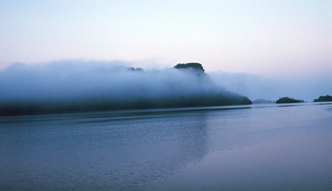 A Low Cloud Sits on the Island's Volcanic Cliffs, February 1973. Pohnpei (Ponape), Federated States of Micronesia. Photo Credit: Dr. James P. McVey, NOAA Sea Grant Program; National Oceanic and Atmospheric Administration Photo Library (http://www.photolib.noaa.gov, mvey0144), Small World Collection, National Oceanic and Atmospheric Administration (NOAA, http://www.noaa.gov), United States Department of Commerce (http://www.commerce.gov), Government of the United States of America (USA).