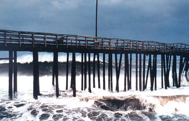 The Wind From the Winter Storm Makes and Raises the Waves and Stirs Up the Atlantic Ocean, But the Exposed Bridge Remains Standing. Outer Banks, State of North Carolina, USA. Photo Credit: Michael Halminski, National Oceanic and Atmospheric Administration Photo Library (http://www.photolib.noaa.gov, wea00824), Historic NWS Collection, NOAA Central Library, National Oceanic and Atmospheric Administration (NOAA, http://www.noaa.gov), United States Department of Commerce (http://www.commerce.gov), Government of the United States of America (USA).