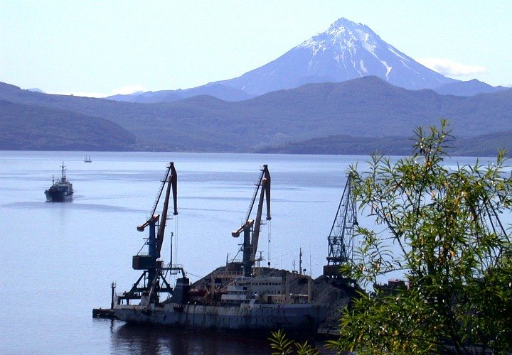 Arriving At and Departing From the Harbor, Seagoing Vessels Have a Grand View of a Portion of Mute Nature That, Day and Night, Visually Communicates Permanence and Protection and Power: The Hills, The Mountains, and a Towering Volcano. Vladivostok, Kamchatka Peninsula, Rossiyskaya Federatsiya - Russian Federation (Russia). Photo Credit: Dr. Igor Smolyar, NODC, NOAA; National Oceanic and Atmospheric Administration Photo Library (http://www.photolib.noaa.gov, mvey0718), Small World Collection, NOAA Central Library, National Oceanic and Atmospheric Administration (NOAA, http://www.noaa.gov), United States Department of Commerce (http://www.commerce.gov), Government of the United States of America (USA).