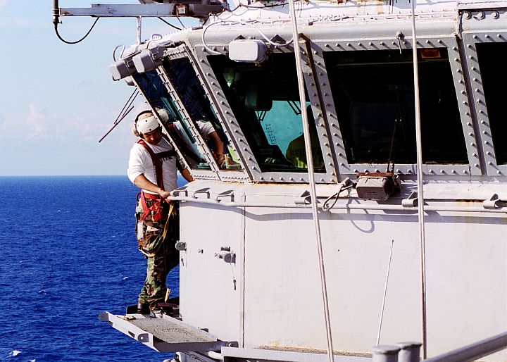 Maneuvering Carefully to Clean Windows Eleven Levels Above the Flight Deck of the Aircraft Carrier USS Enterprise (CVN-65), September 21, 2003, Atlantic Ocean. Photo Credit: Photographer's Mate Airman Brandon E. Holmes, Navy NewsStand - Eye on the Fleet Photo Gallery (http://www.news.navy.mil/view_photos.asp, 030921-N-1087H-001), United States Navy (USN, http://www.navy.mil); United States Department of Defense (DoD, http://www.DefenseLink.mil or http://www.dod.gov), Government of the United States of America (USA).