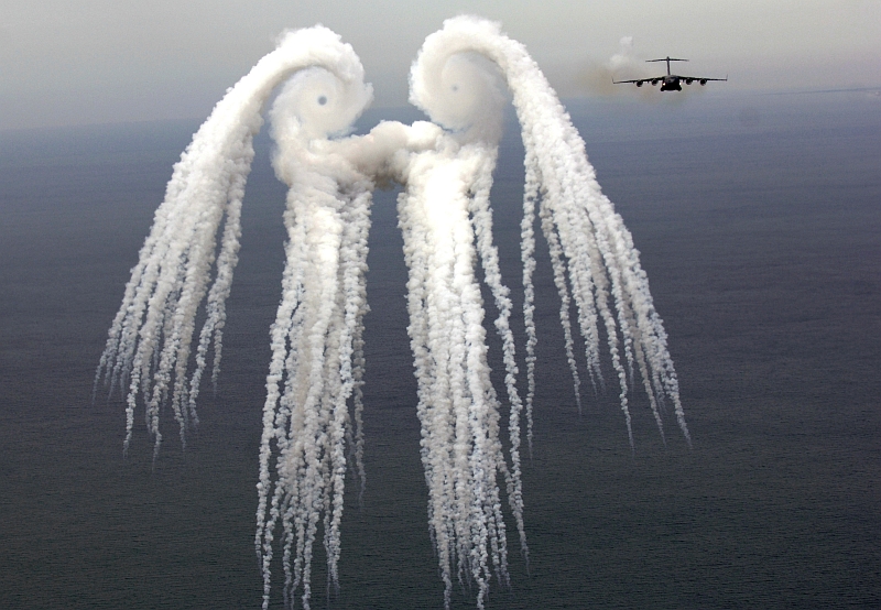 1. The United States Air Force C-17 Globemaster III Military Transport with the 14th Airlift Squadron located at Charleston Air Force Base in South Carolina has flown away after releasing flares over the Atlantic Ocean. Smoke from the flare salvo reveals a beautiful, crisp, startling, and dramatic visual image of the turbulent air -- including two vortices, left and right, each with a visible and defined "eye" -- created by the C-17 Globemaster III as it flies through the air. May 16, 2006, Over the Atlantic Ocean Near Charleston, State of South Carolina, USA. Photo Credit: TSgt. Russell E. Cooley IV, United States Air Force (USAF, http://www.af.mil); Air Force Link - Week in Photos, May 26, 2006 (http://www.af.mil/weekinphotos/060526-03.html and http://www.af.mil/weekinphotos/wipgallery.asp?week=169, 060516-F-9712C-956, "Smoke angel"), United States Air Force (USAF, http://www.af.mil), United States Department of Defense (DoD, http://www.DefenseLink.mil or http://www.dod.gov), Government of the United States of America (USA). C-17 Globemaster III fact sheets from the United States Air Force <http://www.af.mil/factsheets/factsheet.asp?fsID=86> and The Boeing Company <http://www.boeing.com/defense-space/military/c17/index.htm>.