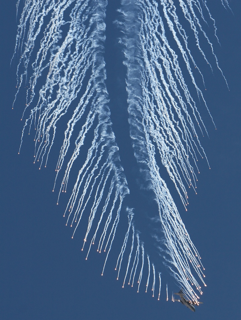 2. A United States Air Force AC-130 Gunship Drops Chaff and Fires Flares During a Firepower Demonstration, September 14, 2007, Nellis Air Force Base, State of Nevada, USA. Photo Credit: Mr. Lawrence Crespo, 99th Communications Squadron, Nellis Air Force Base, United States Air Force (USAF, http://www.af.mil); DefenseLINK News Photos (http://www.DefenseLink.mil/photos/, 070914-F-0528C-004), United States Department of Defense (DoD, http://www.DefenseLink.mil or http://www.dod.gov), Government of the United States of America (USA).