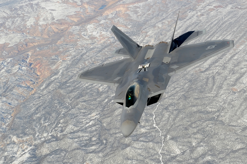 13. U.S. Air Force F-22A Raptor Stealth Fighter Jet Flying Over Snow-Covered Mountains to the Nevada Test and Training Range (Officially Known As Nellis Air Force Range) During the Red Flag 10-2 Exercise, February 4, 2010. Photo Credit: Staff Sgt. Erin T. Worley, United States Air Force; Defense Visual Information (DVI, http://www.DefenseImagery.mil, 100204-F-7348W-057) and United States Air Force (USAF, http://www.af.mil), United States Department of Defense (DoD, http://www.DefenseLink.mil or http://www.dod.gov), Government of the United States of America (USA).