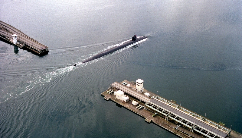 34. USS Ohio (Blue) (SSBN 726), A U.S. Navy Ohio Class Trident Ballistic Missile Submarine, Maneuvers Through the Hood Canal Bridge (William A. Bugge Bridge) As She Returns to Her Homeport In Bangor, March 12, 1998, Bangor, State of Washington, USA. The USS Ohio (SSBN 726) Has Been Redesignated As USS Ohio (SSGN 726). Photo Credit: Photographer's Mate 3rd Class Shawn Handley, United States Navy; Defense Visual Information (DVI, http://www.DefenseImagery.mil, 980312-N-QW321-002, DNSD0104928, and DN-SD-01-04928) and United States Navy (USN, http://www.navy.mil), United States Department of Defense (DoD, http://www.DefenseLink.mil or http://www.dod.gov), Government of the United States of America (USA). Additional details from the U.S. Navy: 'USS OHIO (SSBN 726), USS MICHIGAN (SSBN 727), USS FLORIDA (SSBN 728), and USS GEORGIA (SSBN 729) has been refueled and converted to SSGNs. They have all been redesignated as SSGNs (e.g., SSGN 726, SSGN 727, SSGN 728, and SSGN 729).'