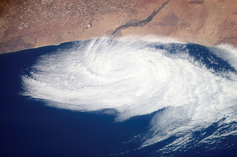 28. Cloud Circulation (Weak Low Pressure System; Latitude: 30 degrees North, Longitude: 9.5 degrees West) Near the Massa River Just South of Agadir, June 26, 2007 at 11:43:02 GMT, Off the Coast of Al Mamlakah al Maghribiyah - Kingdom of Morocco, As Seen From the International Space Station (Expedition 15). NASA; ISS015-E-14392, Clouds, Cloud circulation, Weak low pressure system, Near the Oued Massa River at about 30 degrees north latitude and 9.5 degrees west longitude, South of Agadir, Off the coast of Morocco, International Space Station (Expedition Fifteen); Image Science and Analysis Laboratory, NASA-Johnson Space Center. 'Astronaut Photography of Earth - Display Record.' <http://eol.jsc.nasa.gov/scripts/sseop/photo.pl?mission=ISS015&roll=E&frame=14392>; National Aeronautics and Space Administration (NASA, http://www.nasa.gov), Government of the United States of America (USA).