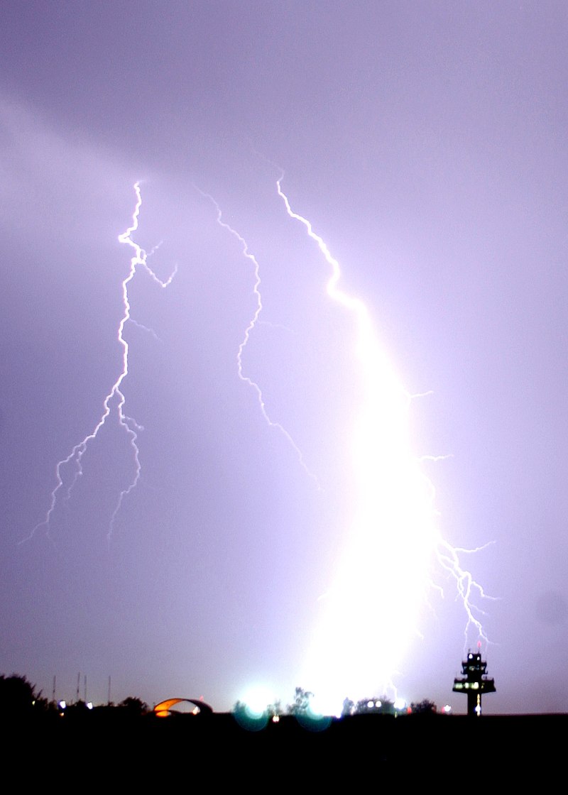 2. The Electrical Storm Continues With Another Spectacular, Very Powerful, Intense, Hot and Massive, Bright, and This Time, Feather-Shaped Lightning Bolt Striking Near the Airport's Control Tower and the Taxiing C-130 Hercules, May 16, 2006, Balad Air Base, Al Jumhuriyah al Iraqiyah - Republic of Iraq. Photo Credit: Senior Airman James Croxon, Air Force Link - Photos (http://www.af.mil/photos, 060516-F-0185C-005, Nature's fireworks), United States Air Force (USAF, http://www.af.mil), United States Department of Defense (DoD, http://www.DefenseLink.mil or http://www.dod.gov), Government of the United States of America (USA).