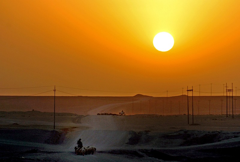 A Splendid Rising or Setting of the Sun Greets the Iraqi Sheepherders As They Move Their Flocks of Sheep to Grazing Land Near Forward Operating Base (FOB) Heider, August 13, 2006, Al Jumhuriyah al Iraqiyah - Republic of Iraq. Photo Credit: Staff Sgt. Russell Lee Klika, United States Army (U. S. Army, http://www.army.mil); Defend America LEAD PHOTOS (http://www..DefendAmerica.mil/indexpage_photos/, September 2006, 'Greener Pastures', 060813-A-0559K-100, http://www.DefendAmerica.mil), United States Department of Defense (DoD, http://www.DefenseLink.mil or http://www.dod.gov), Government of the United States of America (USA).