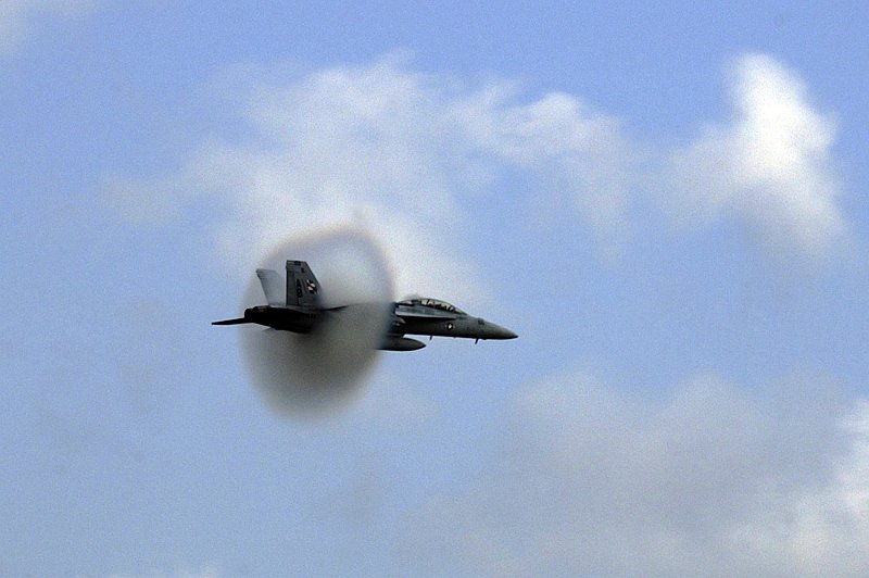 7. An F/A-18F Super Hornet Fighter Jet Assigned to the 'Checkmates' of Strike Fighter Squadron Two One One (VFA-211), 2005 Naval Air Station Oceana Air Show, Naval Air Station Oceana, September 18, 2005, Virginia Beach, Commonwealth of Virginia, USA. Flying at transonic speeds (flying transonically) -- speeds varying near and at the speed of sound (supersonic) -- can generate impressive condensation clouds caused by the Prandtl-Glauert Singularity. For a scientific explanation, see Professor M. S. Cramer's Gallery of Fluid Mechanics, Prandtl-Glauert Singularity at <http://www.GalleryOfFluidMechanics.com/conden/pg_sing.htm>; and Foundations of Fluid Mechanics, Navier-Stokes Equations Potential Flows: Prandtl-Glauert Similarity Laws at <http://www.Navier-Stokes.net/nspfsim.htm>. Photo Credit: Photographer's Mate 3rd Class Layla Pritchett, Navy NewsStand - Eye on the Fleet Photo Gallery (http://www.news.navy.mil/view_photos.asp, 050918-N-2328P-382), United States Navy (USN, http://www.navy.mil), United States Department of Defense (DoD, http://www.DefenseLink.mil or http://www.dod.gov), Government of the United States of America (USA).