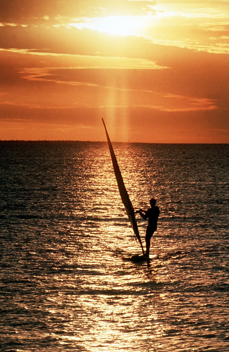 69. A Man Surf Sailing On the Ocean at Sunset Near Commonwealth of Australia. Photo Credit: Master Sgt. (MSGT) David Craft, United States Air Force (USAF, http://www.af.mil); Defense Visual Information Center (DVIC, http://www.DoDMedia.osd.mil, DFST9905360) and United States Air Force (USAF, http://www.af.mil), United States Department of Defense (DoD, http://www.DefenseLink.mil or http://www.dod.gov), Government of the United States of America (USA).