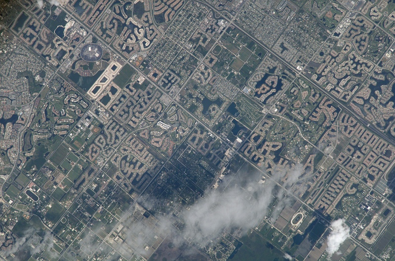 86. Late Morning With Scattered Clouds Over a City In Kalimantan Selatan Province,  Republik Indonesia - Republic of Indonesia, June 25, 2007 at 02:06:11.336 GMT, As Seen From the International Space Station (Expedition 15), Latitude (LAT): -3.3, Longitude (LON): 116.1, Altitude (ALT): 179 Nautical Miles, Sun Azimuth (AZI): 49 degrees, Sun Elevation Angle (ELEV): 48 degrees. Photo Credit: NASA; ISS015-E-13889, City (Town), Kalimantan Selatan Province, Indonesia, International Space Station (Expedition Fifteen); Image Science and Analysis Laboratory, NASA-Johnson Space Center. 'Astronaut Photography of Earth - Display Record.' <http://eol.jsc.nasa.gov/scripts/sseop/photo.pl?mission=ISS015&roll=E&frame=13889>; National Aeronautics and Space Administration (NASA, http://www.nasa.gov), Government of the United States of America (USA).