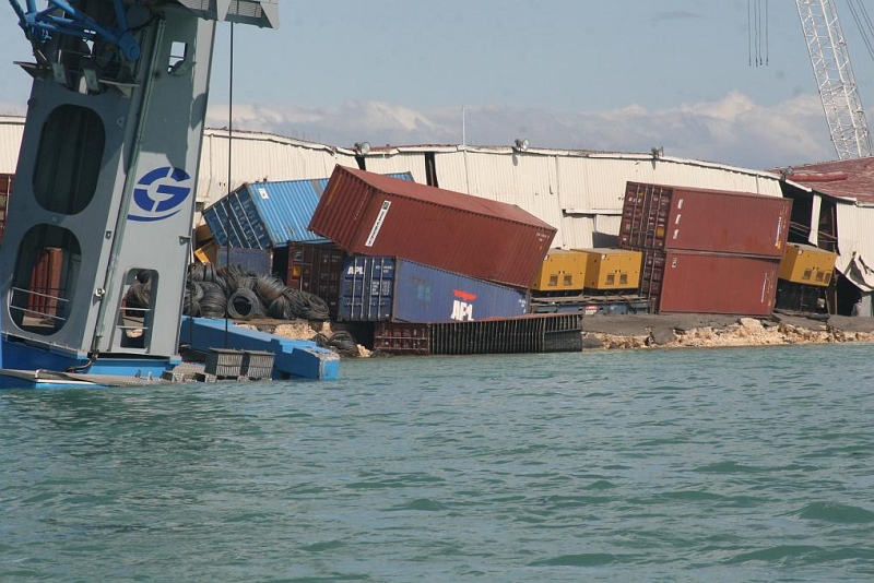 5. Damaged Port Facility and Tumbling Shipping Containers, January 13, 2010, Port-au-Prince, Republique d'Haiti (Repiblik d' Ayiti) - Republic of Haiti. Photo Credit: United States Coast Guard (USCG, http://www.uscg.mil) Visual Information Gallery (http://cgvi.uscg.mil/media/main.php, 100113-G-9999G-050), United States Department of Homeland Security (DHS, http://www.dhs.gov), Government of the United States of America (USA).