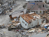 1. An Upended House In the Debris and Rubble In Ofunato, March 15, 2011, Nippon-koku (Nihon-koku) - Japan. Photo Credit: Mass Communication Specialist 1st Class Matthew M. Bradley, United States Navy; Defense Visual Information (DVI, http://www.DefenseImagery.mil, 110315-N-KK192-107) and United States Navy (USN, http://www.navy.mil), United States Department of Defense (DoD, http://www.DefenseLink.mil or http://www.dod.gov), Government of the United States of America (USA).