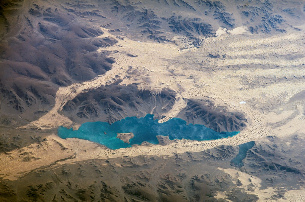 Valley of Lakes: Tobhata Mountains, Har Nuur (Center), Baga Nuur (Lower Right), and Sand Dunes, September 7, 2006 at 08:30:26 GMT, As Seen From the International Space Station (Expedition 13), Latitude (LAT): 51.7, Longitude (LON): 104.3, Altitude (ALT): 184 Nautical Miles, Sun Azimuth (AZI): 242 degrees, Sun Elevation Angle (ELEV): 27 degrees. Photo Credit: NASA; ISS013-E-78506, International Space Station (Expedition Thirteen); Earth Science and Remote Sensing Unit, NASA-Johnson Space Center. "The Gateway to Astronaut Photography of Earth." <http://eol.jsc.nasa.gov/scripts/sseop/photo.pl?mission=ISS013&roll=E&frame=78506>; National Aeronautics and Space Administration (NASA, http://www.nasa.gov), Government of the United States of America (USA).