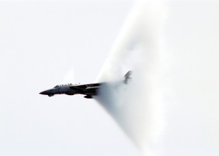 10. An F-14B 'Tomcat' Fighter Jet, April 23, 1999, USS Enterprise (CVN 65), United States Navy Mediterranean Sea. Reaching the sound barrier, breaking the sound barrier: Flying at transonic speeds (flying transonically) -- speeds varying near and at the speed of sound (supersonic) -- can generate impressive condensation clouds caused by the Prandtl-Glauert Singularity. For a scientific explanation, see Professor M. S. Cramer's Gallery of Fluid Mechanics, Prandtl-Glauert Singularity at <http://www.GalleryOfFluidMechanics.com/conden/pg_sing.htm>; and Foundations of Fluid Mechanics, Navier-Stokes Equations Potential Flows: Prandtl-Glauert Similarity Laws at <http://www.Navier-Stokes.net/nspfsim.htm>. Photo Credit: Photographer's Mate Second Class Damon J. Moritz, Image ID: 990423-N-9693M-001, Expeditionary Warfare Division (N75) in the Office of the Chief of Naval Operations, United States Navy (USN, http://www.navy.mil), United States Department of Defense (DoD, http://www.DefenseLink.mil or http://www.dod.gov), Government of the United States of America (USA).