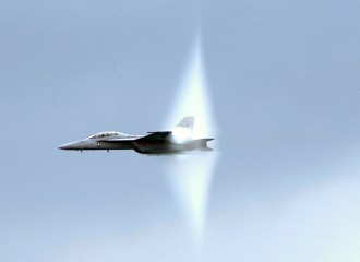 14. 47th Annual Chicago Air and Water Show at North Avenue Beach, August 20, 2005: A United States Navy F/A-18F Super Hornet Fighter Jet, assigned to the 'Gladiators' of Strike Fighter Squadron One Zero Six (VFA-106), Flying Over Lake Michigan With Its Prandtl-Glauert Cloud. Chicago, State of Illinois, USA. Reaching the sound barrier, breaking the sound barrier: Flying at transonic speeds (flying transonically) -- speeds varying near and at the speed of sound (supersonic) -- can generate impressive condensation clouds caused by the Prandtl-Glauert Singularity. For a scientific explanation, see Professor M. S. Cramer's Gallery of Fluid Mechanics, Prandtl-Glauert Singularity at <http://www.GalleryOfFluidMechanics.com/conden/pg_sing.htm>; and Foundations of Fluid Mechanics, Navier-Stokes Equations Potential Flows: Prandtl-Glauert Similarity Laws at <http://www.Navier-Stokes.net/nspfsim.htm>. Photo Credit: Photographer's Mate 1st Class Steve Schmidt, Navy NewsStand - Eye on the Fleet Photo Gallery (http://www.news.navy.mil/view_photos.asp, 050820-N-6727S-505), United States Navy (USN, http://www.navy.mil), United States Department of Defense (DoD, http://www.DefenseLink.mil or http://www.dod.gov), Government of the United States of America (USA).