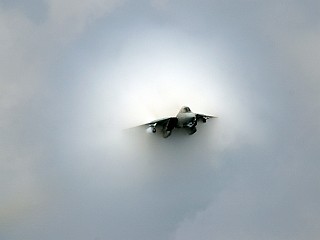 15. An F-14D Tomcat Fighter Jet, July 28, 2006, USS Theodore Roosevelt (CVN 71), United States Navy, Atlantic Ocean. Reaching the sound barrier, breaking the sound barrier: Flying at transonic speeds (flying transonically) -- speeds varying near and at the speed of sound (supersonic) -- can generate impressive condensation clouds caused by the Prandtl-Glauert Singularity. For a scientific explanation, see Professor M. S. Cramer's Gallery of Fluid Mechanics, Prandtl-Glauert Singularity at <http://www.GalleryOfFluidMechanics.com/conden/pg_sing.htm>; and Foundations of Fluid Mechanics, Navier-Stokes Equations Potential Flows: Prandtl-Glauert Similarity Laws at <http://www.Navier-Stokes.net/nspfsim.htm>. Photo Credit: Mass Communication Specialist 3rd Class Nathan Laird, Navy NewsStand - Eye on the Fleet Photo Gallery (http://www.news.navy.mil/view_photos.asp, 060728-N-7241L-026), United States Navy (USN, http://www.navy.mil), United States Department of Defense (DoD, http://www.DefenseLink.mil or http://www.dod.gov), Government of the United States of America (USA). See also the companion photo in 'F-14 near supersonic fly-by' at <http://www.navy.mil/view_single.asp?id=37558>.