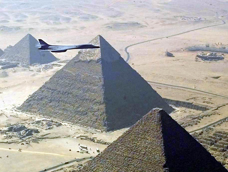 1. Aerial View of the Pyramids and a United States Air Force (USAF) B-1B Lancer Bomber, 1999, Jumhuriyat Misr al-Arabiyah - Arab Republic of Egypt (Egypt). Photo Credit: Air Force Link - Photos (http://www.af.mil/photos, 021105-O-9999G-017, "Flying over foreign lands"), United States Air Force (USAF, http://www.af.mil), United States Department of Defense (DoD, http://www.DefenseLink.mil or http://www.dod.gov), Government of the United States of America (USA).