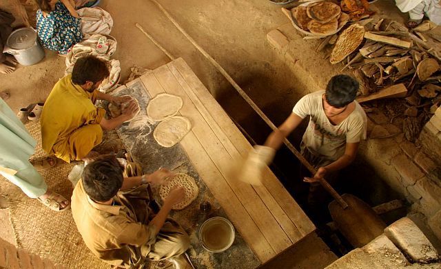 1. Wheat Bread Dough is Pressed, Tossed, and Dimpled by Afghan Men for the Makeshift Bakeries in Refugee Camps Near the Border Between Afghanistan and Pakistan, November 15, 2001. Dowlat-e Eslami-ye Afghanestan - Transitional Islamic State of Afghanistan. Photo Credit: Martin Lueders, USAID Humanitarian Crisis in Central Asia - Photos from the Field (http://www.usaid.gov/press/releases/2001/images/centralasia.html), United States Agency for International Development (USAID, http://www.usaid.gov), Government of the United States of America (USA).