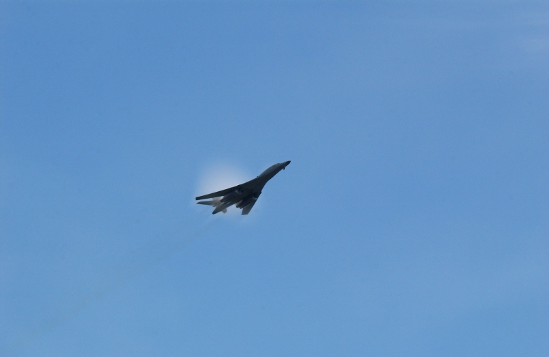 3. A B-1B Lancer Bomber Creating a Prandtl-Glauert Condensation Cloud, United States Air Force. January 16, 2004, Southwest Asia. USAF image ID number: 040116-F-0971G-143. Flying at transonic speeds -- speeds varying near and at the speed of sound (supersonic) -- can generate impressive condensation clouds caused by the Prandtl-Glauert Singularity. For a scientific explanation, see Dr. Mark. S. Cramer's Gallery of Fluid Mechanics, Prandtl-Glauert Singularity at <http://www.GalleryOfFluidMechanics.com/conden/pg_sing.htm>; the Prandtl-Glauert Condensation Clouds tutorial at <http://FluidMech.net/tutorials/sonic/prandtl-glauert-clouds.htm>; and Foundations of Fluid Mechanics, Navier-Stokes Equations Potential Flows: Prandtl-Glauert Similarity Laws at <http://www.Navier-Stokes.net/nspfsim.htm>. Photo Credit: Staff Sgt. Shelley Gill, Still Photography Journeyman, 125th Fighter Wing, Florida Air National Guard, USA; 040116-F-0971G-143, United States Air Force (USAF, http://www.af.mil), United States Department of Defense (DoD, http://www.DefenseLink.mil or http://www.dod.gov), Government of the United States of America (USA).