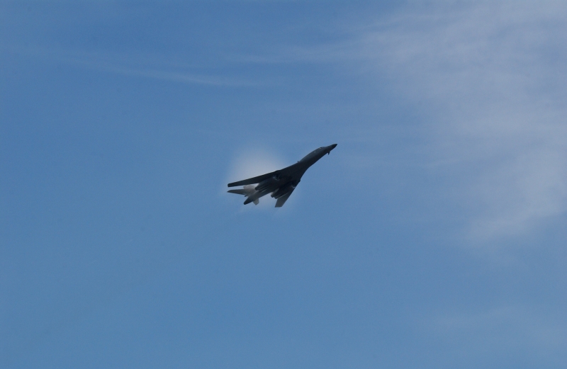 4. A B-1B Lancer Bomber Creating a Prandtl-Glauert Condensation Cloud, United States Air Force. January 16, 2004, Southwest Asia. USAF image ID number: SAF, 040116-F-0971G-144. Flying at transonic speeds -- speeds varying near and at the speed of sound (supersonic) -- can generate impressive condensation clouds caused by the Prandtl-Glauert Singularity. For a scientific explanation, see Dr. Mark. S. Cramer's Gallery of Fluid Mechanics, Prandtl-Glauert Singularity at <http://www.GalleryOfFluidMechanics.com/conden/pg_sing.htm>; the Prandtl-Glauert Condensation Clouds tutorial at <http://FluidMech.net/tutorials/sonic/prandtl-glauert-clouds.htm>; and Foundations of Fluid Mechanics, Navier-Stokes Equations Potential Flows: Prandtl-Glauert Similarity Laws at <http://www.Navier-Stokes.net/nspfsim.htm>. Photo Credit: Staff Sgt. Shelley Gill, Still Photography Journeyman, 125th Fighter Wing, Florida Air National Guard, USA; SAF, 040116-F-0971G-144, United States Air Force (USAF, http://www.af.mil), United States Department of Defense (DoD, http://www.DefenseLink.mil or http://www.dod.gov), Government of the United States of America (USA).