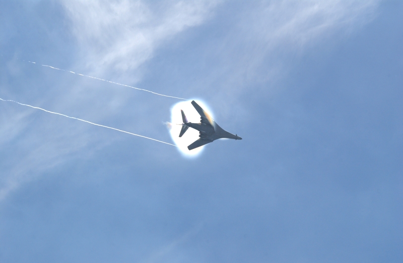 11. A B-1B Lancer Bomber Creating a Prandtl-Glauert Condensation Cloud, United States Air Force. January 16, 2004, Southwest Asia. USAF image ID number: 040116-F-0971G-155. Flying at transonic speeds -- speeds varying near and at the speed of sound (supersonic) -- can generate impressive condensation clouds caused by the Prandtl-Glauert Singularity. For a scientific explanation, see Dr. Mark. S. Cramer's Gallery of Fluid Mechanics, Prandtl-Glauert Singularity at <http://www.GalleryOfFluidMechanics.com/conden/pg_sing.htm>; the Prandtl-Glauert Condensation Clouds tutorial at <http://FluidMech.net/tutorials/sonic/prandtl-glauert-clouds.htm>; and Foundations of Fluid Mechanics, Navier-Stokes Equations Potential Flows: Prandtl-Glauert Similarity Laws at <http://www.Navier-Stokes.net/nspfsim.htm>. Photo Credit: Staff Sgt. Shelley Gill, Still Photography Journeyman, 125th Fighter Wing, Florida Air National Guard, USA; 040116-F-0971G-155, United States Air Force (USAF, http://www.af.mil), United States Department of Defense (DoD, http://www.DefenseLink.mil or http://www.dod.gov), Government of the United States of America (USA).