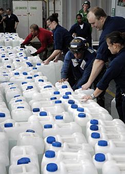 3. Jugs of Purified Water Ready For Distribution in Sumatra, Republik Indonesia, January 4, 2005, USS Abraham Lincoln (CVN 72), Indian Ocean. Photo Credit: Photographer's Mate Airman Jordon R. Beesley, Navy NewsStand - Eye on the Fleet Photo Gallery (http://www.news.navy.mil/view_photos.asp, 050104-N-4166B-184), United States Navy (USN, http://www.navy.mil), United States Department of Defense (DoD, http://www.DefenseLink.mil or http://www.dod.gov), Government of the United States of America (USA).