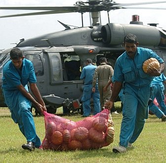 2. Unloading a bag of vegetables from the United States Air Force HH-60G Pave Hawk helicopter in Sri Lanka, one of the countries devastated by the wall of water caused by "The Great Earthquake and Catastrophic Tsunami of 2004" <http://ChamorroBible.org/gpw/gpw-The-Great-Earthquake-and-Catastrophic-Tsunami-of-2004.htm>. January 12, 2005, Dambula, Democratic Socialist Republic of Sri Lanka. Photo Credit: United States Air Force Master Sgt. Val Gempis, DefenseLINK News Photos - Unified Assistance (http://www.DefenseLink.mil/photos/Operations/UnifiedAssistance, January 14, 2005, 050112-F-1740G-005, "Sri Lankan workers unload bags of vegetables from a U.S. Air Force HH-60 Pavehawk helicopter."), United States Air Force (USAF, http://www.af.mil), United States Department of Defense (DoD, http://www.DefenseLink.mil or http://www.dod.gov), Government of the United States of America (USA).