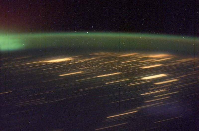 7. Green Aurora Borealis and City Lights at Night, March 30, 2003 As Seen From the International Space Station (Expedition 6). Photo Credit: NASA; ISS006-E-41641, Green Aurora Borealis, City lights, Night, International Space Station (Expedition Six); Image Science and Analysis Laboratory, NASA-Johnson Space Center. 'Astronaut Photography of Earth - Display Record.' <http://eol.jsc.nasa.gov/scripts/sseop/photo.pl?mission=ISS006&roll=E&frame=41641>; National Aeronautics and Space Administration (NASA, http://www.nasa.gov), Government of the United States of America (USA).