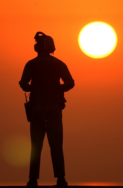 Watching the Sun and a Beautiful Orange Sunset Over the Calm Arabian Sea From the United States Navy USS Abraham Lincoln (CVN 72), October 29, 2002. Photo Credit: Photographer's Mate 2nd Class Aaron Ansarov, Navy NewsStand - Eye on the Fleet Photo Gallery (http://www.news.navy.mil/view_photos.asp, 021029-N-4309A-010), United States Navy (USN, http://www.navy.mil), United States Department of Defense (DoD, http://www.DefenseLink.mil or http://www.dod.gov), Government of the United States of America (USA).