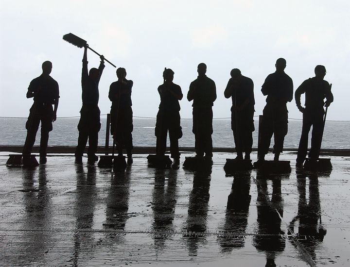 Scrubbing the USS Theodore Roosevelt's (CVN 71) Flight Decks and Catwalks With Long-Handle Brushes Removes Hydraulic Fluid, Grease and Dirt Buildup Keeps the Aircraft Carrier Safe for People and Machines, July 10, 2005 in the Atlantic Ocean. Photo Credit: Photographer's Mate Airman Sheldon Rowley, Navy NewsStand – Eye on the Fleet Photo Gallery (http://www.news.navy.mil/view_photos.asp, 050710-N-5248R-005), United States Navy (USN, http://www.navy.mil); United States Department of Defense (DoD, http://www.DefenseLink.mil or http://www.dod.gov), Government of the United States of America (USA).