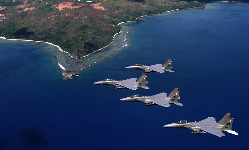 2. The Hills and Coast of Guam's Southern Point Are Visible As Four USAF F-15E Strike Eagle Fighter Jets Fly In Formation Over the Ocean, June 16, 2005, Territory of Guam, USA. Photo Credit: Tech. Sgt. Cecilio M. Ricardo, Air Force Link - Photos (http://www.af.mil/photos, 050617-F-3961R-290, 'Soaring like an Eagle'), United States Air Force (USAF, http://www.af.mil), United States Department of Defense (DoD, http://www.DefenseLink.mil or http://www.dod.gov), Government of the United States of America (USA).