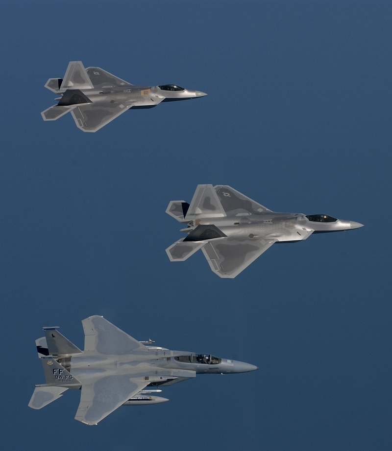 22. Two USAF F/A-22 (F-22A) Raptor Stealth Fighter Jets and A USAF F-15 Eagle Flying In Formation During A Training Sortie, August 12, 2005, Off the Coast of Langley Air Force Base (AFB), Commonwealth of Virginia, USA. Photo Credit: Tech. Sgt. Ben Bloke, United States Air Force; Defense Visual Information (DVI, http://www.DefenseImagery.mil, 050812-F-YL744-036) and United States Air Force (USAF, http://www.af.mil), United States Department of Defense (DoD, http://www.DefenseLink.mil or http://www.dod.gov), Government of the United States of America (USA).