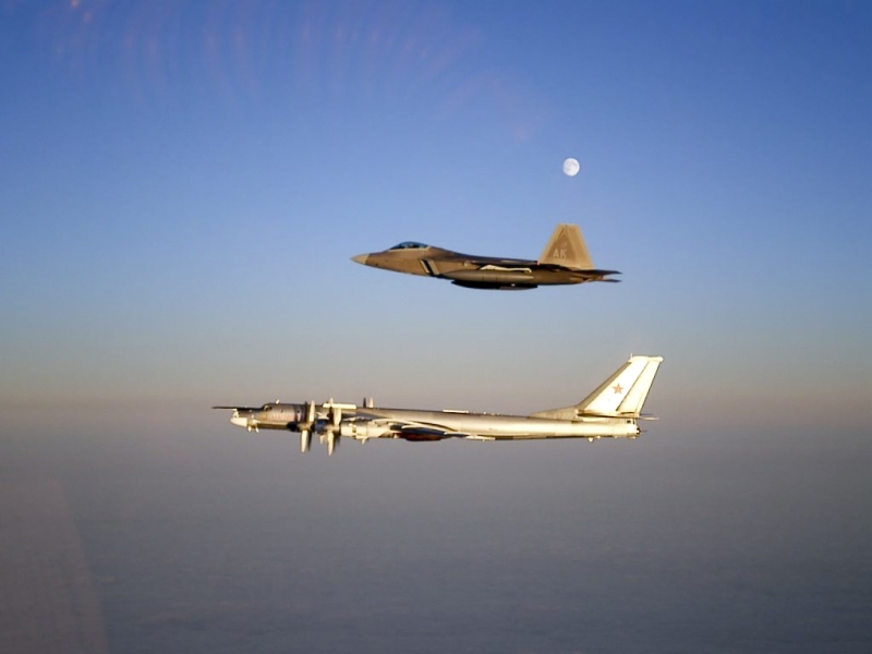 12. A U.S. Air Force F-22A Raptor Stealth Fighter Jet Intercepting and Escorting A Russian Tu-95MS Strategic Heavy Bomber Under A Full Moon, November 22, 2007, Near Alaskan NORAD Region Airspace. Photo Credit: United States Air Force; AF.mil - Photos (http://www.af.mil/photos, 071122-F-1234X-001, "ANR [Alaskan North American Aerospace Defense Command (NORAD) Region] celebrates 50 years protecting Alaskan skies"), United States Department of Defense (DoD, http://www.DefenseLink.mil or http://www.dod.gov), Government of the United States of America (USA). Additional details from the USAF: Two F-22 Raptors from 11th Air Force, 3rd Wing, based at Elmendorf Air Force Base, Alaska intercepted a pair of Russian Tu-95MS strategic bombers on November 22, 2007. Both "Bears" belong to the 326th Heavy Bomber Air Division and are operated from Ukrainka air base. The intercept was a first for the Raptor.