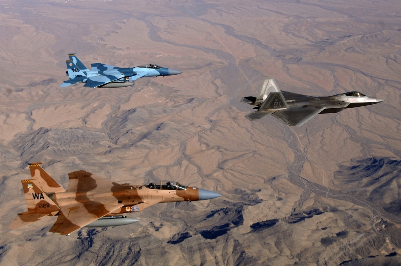 7. With Bare Mountains Below, Two USAF F-15 Eagle Fighter Jets (65th Aggressor Squadron) and One USAF F-22A Raptor Stealth Fighter Jet (422nd Test and Evaluation Squadron) Fly In Formation During A Training Mission Near Nellis Air Force Base, State of Nevada, USA, April 24, 2008. Photo Credit: Master Sgt. Scott Reed, United States Air Force; Defense Visual Information (DVI, http://www.DefenseImagery.mil, 080424-F-4884R-020) and United States Air Force (USAF, http://www.af.mil), United States Department of Defense (DoD, http://www.DefenseLink.mil or http://www.dod.gov), Government of the United States of America (USA).