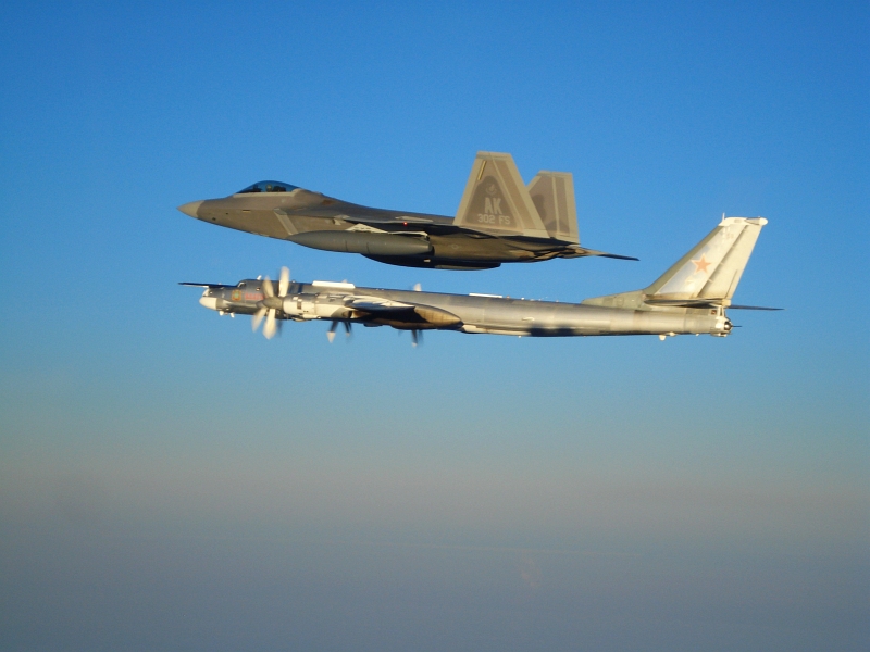 11. Side By Side: A U.S. Air Force F-22A Raptor Stealth Fighter Jet Escorts A Russian Tu-95MS Strategic Heavy Bomber, November 22, 2007, Near Alaskan NORAD Region Airspace. Photo Credit: United States Air Force; Pacific Air Forces - Photos (http://www.pacaf.af.mil/photos, 081010-F-1234X-020, "F-22 Raptor intercepts Russian bomber"), United States Department of Defense (DoD, http://www.DefenseLink.mil or http://www.dod.gov), Government of the United States of America (USA). Additional information provided by the USAF: Two F-22 Raptors from 11th Air Force, 3rd Wing, based at Elmendorf Air Force Base, Alaska intercepted a pair of Russian Tu-95MS strategic bombers on November 22, 2007. Both "Bears" belong to the 326th Heavy Bomber Air Division and are operated from Ukrainka air base. The intercept was a first for the Raptor.