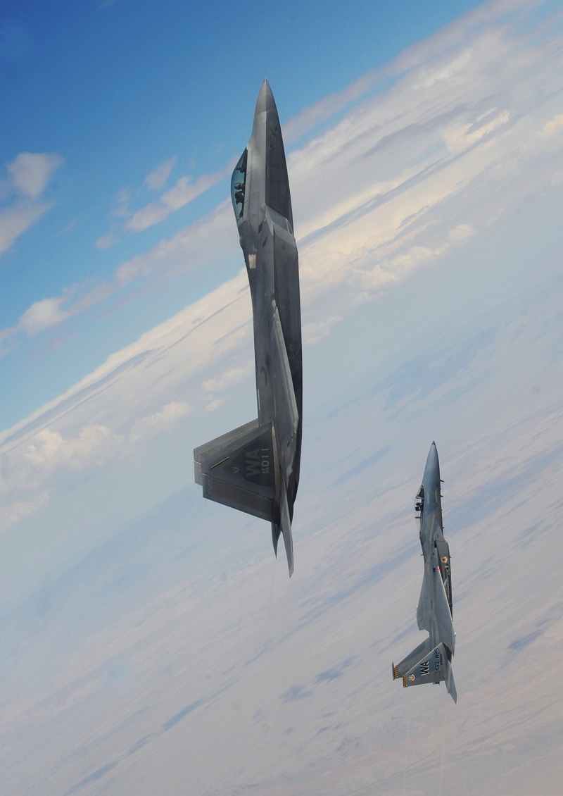 14. A U.S. Air Force F-22A Raptor Stealth Fighter and A U.S. Air Force F-15C Eagle Fighter Jet Pull Into a Vertical Climb Above the Nevada Test and Training Range (Officially Known As Nellis Air Force Range), July 16, 2010, State of Nevada, USA. Photo Credit: Master Sgt. Kevin J. Gruenwald, United States Air Force; United States Air Force; AF.mil - Photos (http://www.af.mil/photos, 100716-F-6911G-012), United States Department of Defense (DoD, http://www.DefenseLink.mil or http://www.dod.gov), Government of the United States of America (USA).