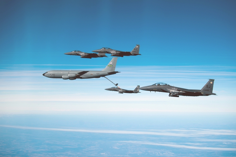 18. A United States Air Force (USAF) KC-135R Stratotanker Refuels A USAF F-15E Strike Eagle Fighter Jet In the Presence of Three Additional USAF F-15E Strike Eagle Fighter Jets, December 17, 2010, State of North Carolina, USA. Photo Credit: Staff Sgt. Michael B. Keller, United States Air Force; Defense Visual Information (DVI, http://www.DefenseImagery.mil, 101217-F-SF570-212) and United States Air Force (USAF, http://www.af.mil), United States Department of Defense (DoD, http://www.DefenseLink.mil or http://www.dod.gov), Government of the United States of America (USA).