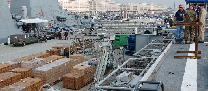 Food for State of Florida, USA Residents Affected by Hurricane Wilma: Personnel Aboard the Amphibious Transport Dock USS Nashville (LPD 13) Discuss How to Move Pallets of Meals Ready-to Eat (MRE) Onto the Ship, October 20, 2005. Naval Station Norfolk, Commonwealth of Virginia, USA. Photo Credit (Full size): Journalist Seaman Davis J. Anderson, Navy NewsStand - Eye on the Fleet Photo Gallery (http://www.news.navy.mil/view_photos.asp, 051020-N-3541A-004), United States Navy (USN, http://www.navy.mil); United States Department of Defense (DoD, http://www.DefenseLink.mil or http://www.dod.gov), Government of the United States of America (USA).