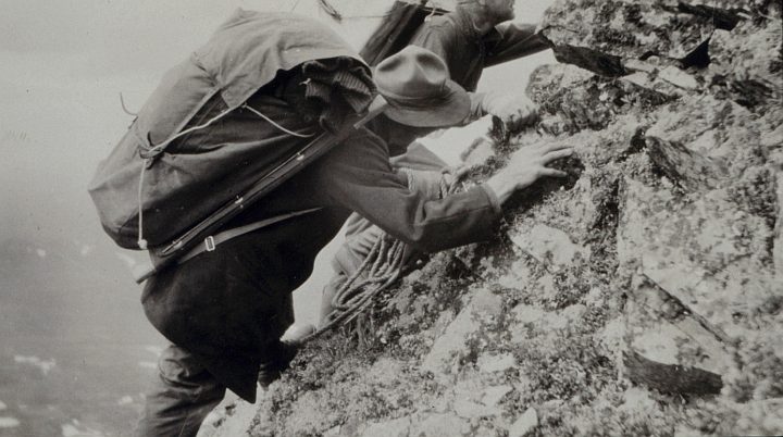 Climbing Station Wolverine is Hard and Dangerous for the Triangulation Party of William M. Scaife, 1923. State of Alaska (Central), USA. Photo Credit: C&GS Season's Report Scaife 1924, National Oceanic and Atmospheric Administration Photo Library (http://www.photolib.noaa.gov, theb0733), Historic C&GS Collection, NOAA Central Library, National Oceanic and Atmospheric Administration (NOAA, http://www.noaa.gov), United States Department of Commerce (http://www.commerce.gov), Government of the United States of America (USA).