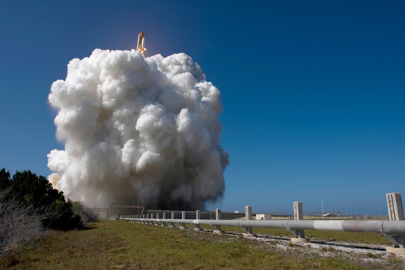 23. Space Shuttle Discovery (STS-124) Emerges From Behind a Growing Cloud of Smoke During Liftoff, May 31, 2008, NASA Kennedy Space Center, State of Florida, USA. Photo Credit: Sandra Joseph, Tony Gray, Robert Murray, and Mike Kerley; Kennedy Media Gallery (http://mediaarchive.ksc.nasa.gov) Photo Number: KSC-08PD-1554, John F. Kennedy Space Center (KSC, http://www.nasa.gov/centers/kennedy), National Aeronautics and Space Administration (NASA, http://www.nasa.gov), Government of the United States of America.