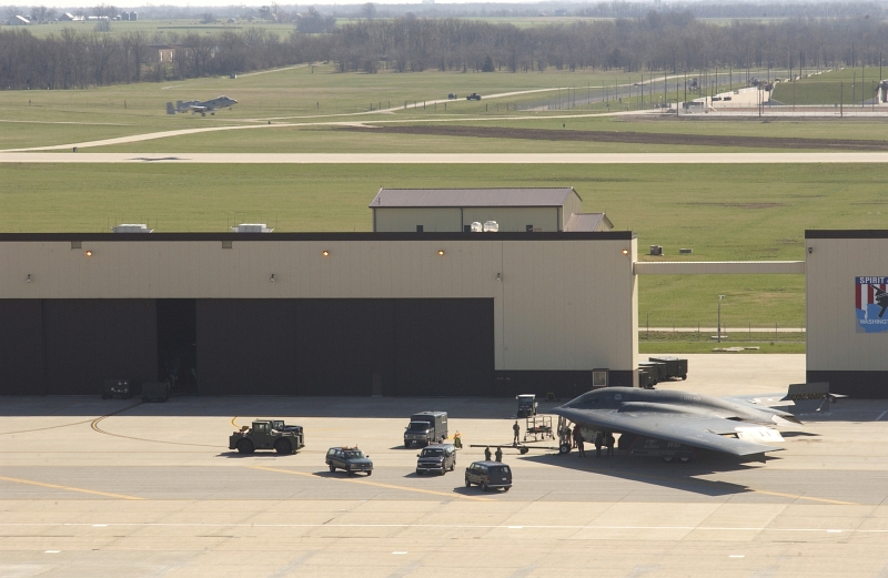 30. A U.S. Air Force A-10 Thunderbolt II Takes Off (Background) As Maintenance Crews Recover A U.S. Air Force B-2 Spirit Stealth Bomber (Foreground) Just Returning From A Combat Mission Over Iraq During Operation Iraqi Freedom, April 1, 2003, Whiteman Air Force Base, State of Missouri, USA. Photo Credit: TSgt. Michael R. Nixon, United States Air Force; Defense Visual Information (DVI, http://www.DefenseImagery.mil, 030401-F-WM157-005) and United States Air Force (USAF, http://www.af.mil), United States Department of Defense (DoD, http://www.DefenseLink.mil or http://www.dod.gov), Government of the United States of America (USA).