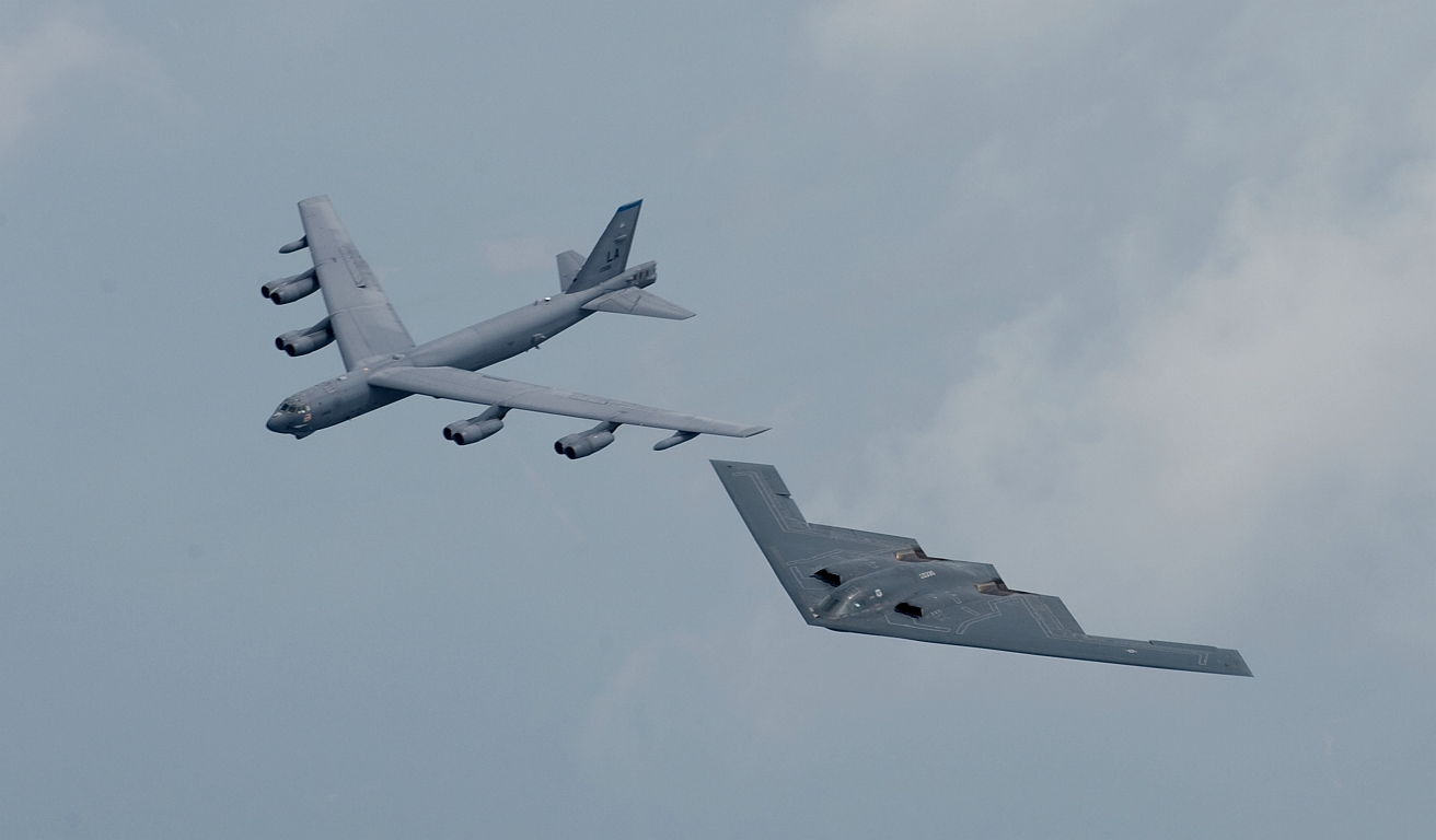 2. B-52 Stratofortress (left) and B-2 Spirit (right) fly in formation over Shreveport, Louisiana, USA, on 10 May 2008 for the 75th Anniversary of Barksdale Air Force Base (AFB) celebration. Image ID: 080510-F-0986R-005