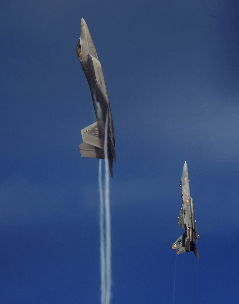 17. A U.S. Air Force F-22A Raptor Stealth Fighter and a U.S. Air Force F-15C Eagle Fighter Jet Pull Into a Vertical Climb Over the Nevada Test and Training Range (Officially Known As Nellis Air Force Range), July 16, 2010, State of Nevada, USA. Photo Credit: Master Sgt. Kevin J. Gruenwald, United States Air Force; United States Air Force; AF.mil - Photos (http://www.af.mil/photos, 100716-F-6911G-491), United States Department of Defense (DoD, http://www.DefenseLink.mil or http://www.dod.gov), Government of the United States of America (USA).